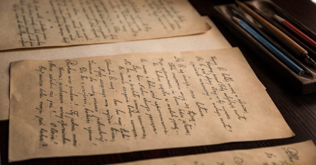 Authentic vintage handwritten letters on a rustic table with pens.